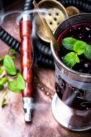 Smoking oriental hookah with alcohol berry cocktailの写真素材