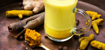 Turmeric Golden milk in a glass cupの写真素材