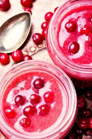 Blended red smoothie with cranberries in glass jarの写真素材