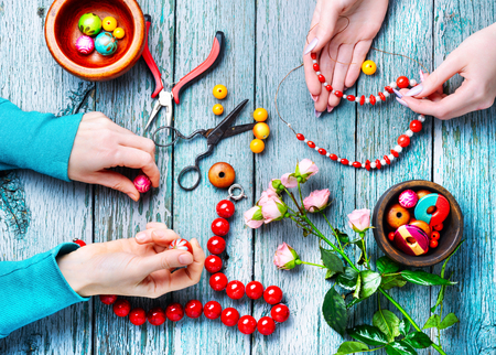 Two pairs of hands make a female bead ornamentの写真素材