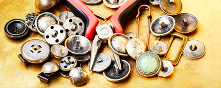 Buttons from clothes, sewing tool and pliersの写真素材