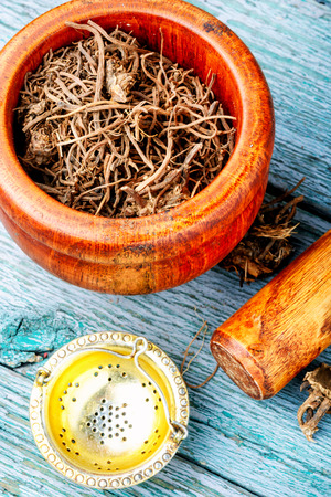 Traditional folk remedy from valerian roots in a mortarの写真素材