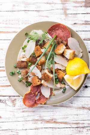 Salad with fried bacon, croutons and Jerusalem artichokeの写真素材