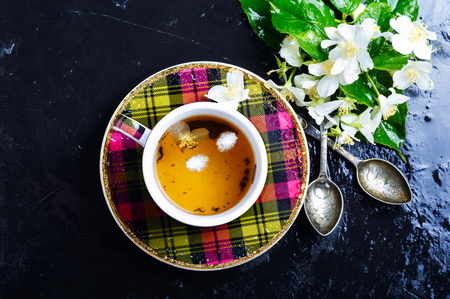 Teacup with tea from jasmine flowers.の写真素材