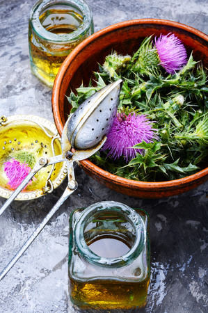 Healing plant of thistle and medical bottles with extract.Herbalismの写真素材