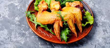 Smoked chicken wings and leaf salad. Fast foodの写真素材