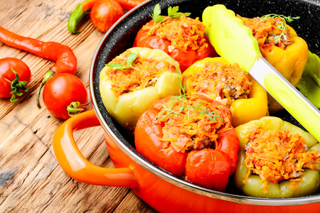 Red and yellow bell stuffed peppers with rice and minced meatの写真素材