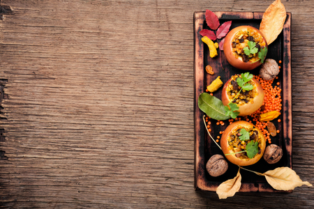 Apples baked with lentils, raisins and spices. Autumn meal.の写真素材