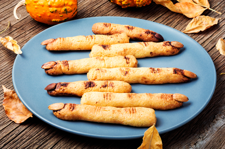 Halloween finger cookies on wooden table. Halloween party.の写真素材