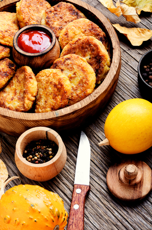 Vegetarian cutlets from autumn pumpkin on a wooden table. Autumn foodの写真素材