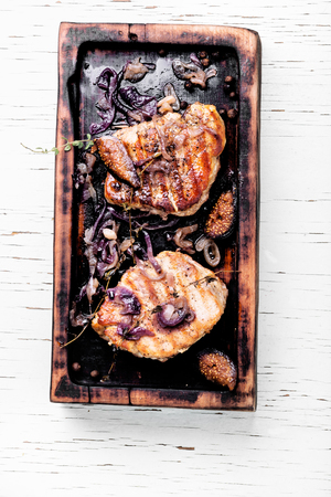 Cooked rump steak with spices served on wooden cutting boardの写真素材