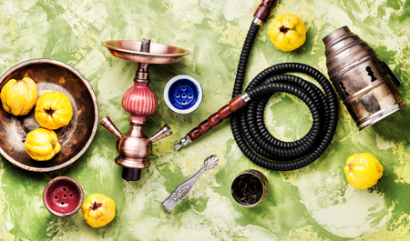Oriental smoking hookah with mouthpieces with quince flavor.Shisha advertising
