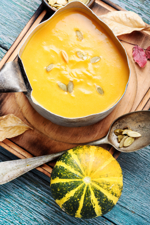 Autumn pumpkin soup in a metal saucepan.Autumn foodの写真素材