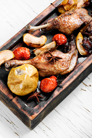 Grilled duck legs baked with apples and vegetables. Dietary meatの写真素材