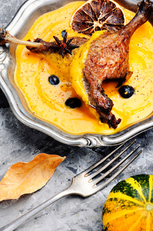 Appetizing roasted duck leg in pumpkin puree.Duck meat. Italian foodの写真素材