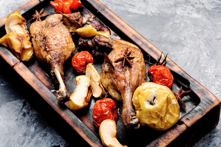 Appetizing roasted duck leg with apples and vegetables.Duck meatの写真素材