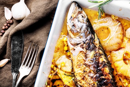 Delicious roasted fish with pineapple.Fishes baked in baking dishの写真素材