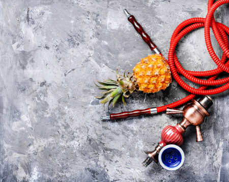 Fashionable fruit smoking hookah with a tobacco flavor of pineapple.Eastern shisha.Smoking hookah.の写真素材