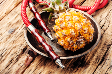 Fashionable fruit smoking hookah with a tobacco flavor of pineapple.Eastern shisha.Smoking hookah.の写真素材