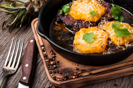 Grilled steak with pineapple n pan on wooden cutting boardの写真素材