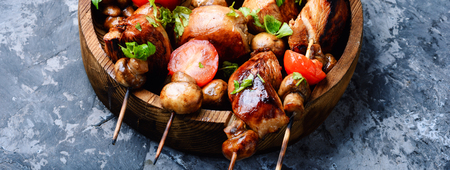 Chicken kebab on skewers with mushrooms and tomato.の写真素材