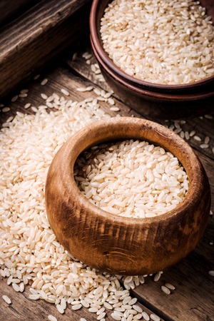 Uncooked dry rice in bowl.Thailand Rice in wooden bowlの写真素材