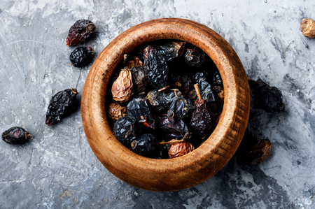 Dried red rose hips in bowl.Medicinal plantsの写真素材