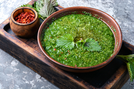 Nettle soup in bowl on wooden surface.Green nettle soupの写真素材