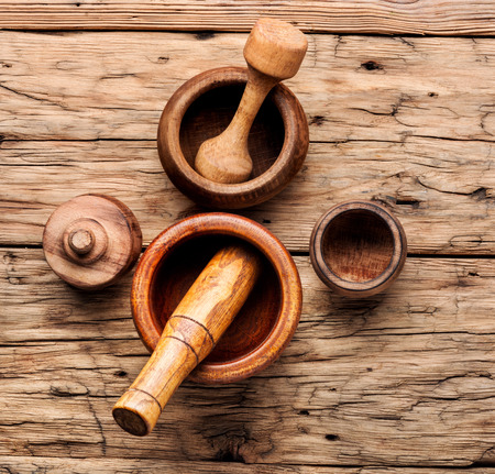 Empty wooden mortar and pestle on wooden old background.Cooking utensilsの写真素材