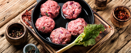 Meat balls from raw beef force-meat in iron cast panの写真素材