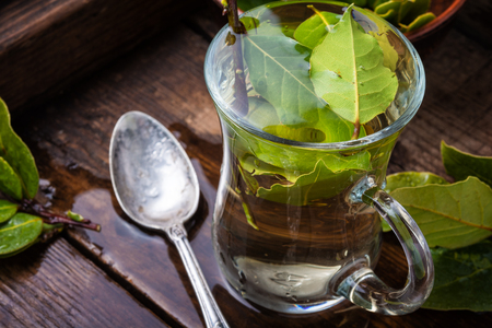 Herbal tea with bay leaf on old wooden backgroundの写真素材
