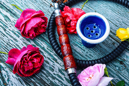 Turkish smoking hookah with the scent of tea rose. Flower tobacco. Smoking. Fashionable shishaの写真素材