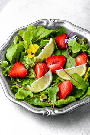 Salad with greens, strawberries and lime.Summer food.Summer dishの写真素材