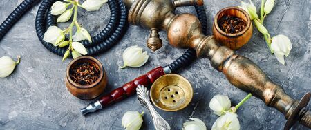 Turkish smoking hookah with the scent of yucca.Flower tobacco.Smoking.Tobacco pipe and smoking tobacco with yucca flavor.Refined taste of tobaccoの写真素材