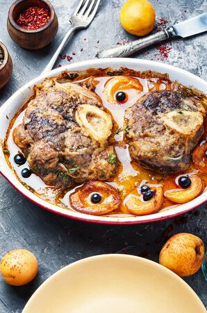 Ossobuco, traditional dish of Italian cuisine.Stewed veal leg.Meat stew with apricotの写真素材