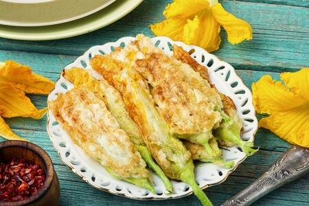Fried zucchini flowers stuffed with cream cheese.Stuffed zucchini or courgette flowersの写真素材