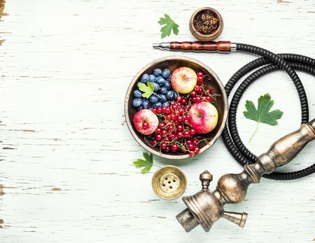 Tobacco hookah.Shisha mouthpiece and parts for the smoking hookah.Kalian with berries and apple