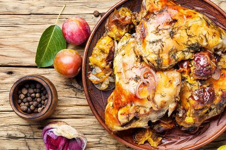 Roasted chicken on wooden table.Fried chicken meat in plum sauce.Autumn foodの写真素材
