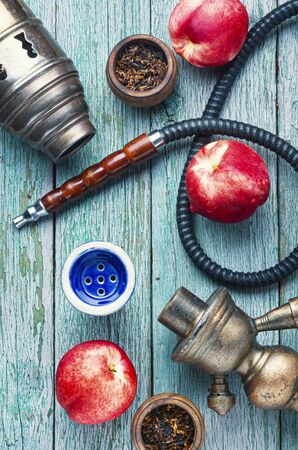 Tobacco shisha with nectarine flavor.Hookah with peachの写真素材