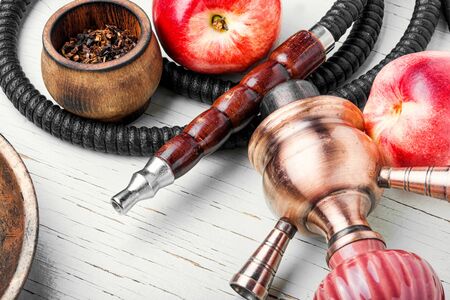 Tobacco shisha with nectarine flavor.Hookah with peach.Fruit hookah tobaccoの写真素材