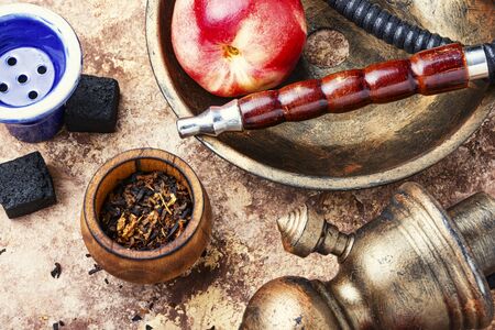 Tobacco shisha with nectarine flavor.Hookah with peachの写真素材