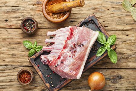 Ribs and pork chops on old wooden tableの写真素材