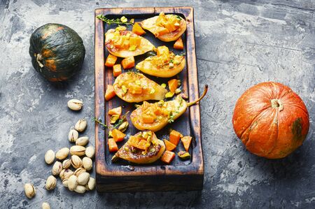 Stuffed pear pumpkin and pistachio. Baked pear. Autumn food.の写真素材