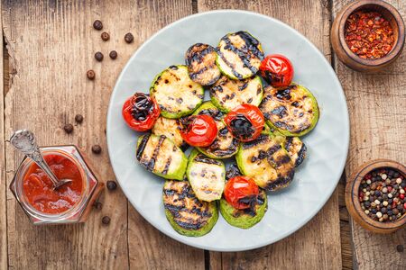 Grilled vegetables on wooden table.Large portion of grilled vegetablesの写真素材