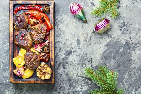 Grilled beef with vegetables to the Christmas table.Veal in pomegranate sauce.Christmas dinnerの写真素材