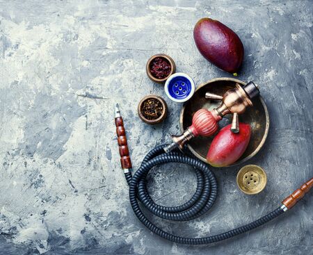 Smoking hookah.Details of shisha.Shisha with mango aroma of tobacco.