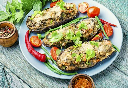 Baked eggplant stuffed with mushrooms and tomatoes. Vegetarian food.の写真素材
