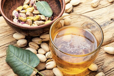Beer glasses on old wooden table.Beer and salted pistachiosの写真素材
