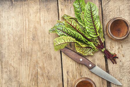 Bunch of fresh sorrel on wooden table.Sorrel bloody mary.Space for text