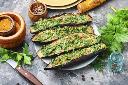 Halved homemade eggplant with garlic and parsley.Fried eggplant with herbs.Vegetarian food.の写真素材